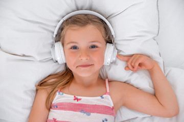 Mädchen hört im Bett Musik