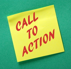 The phrase Call to Action in red text on a yellow sticky note posted on a green notice board as a reminder