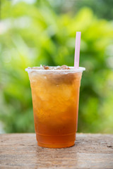 Longan juice in plastic glass with green leaf natural background