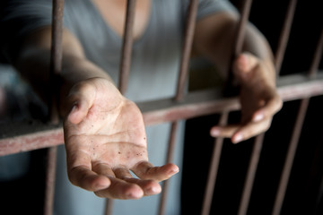 Fototapeta na wymiar prisoner with begging hand in jail