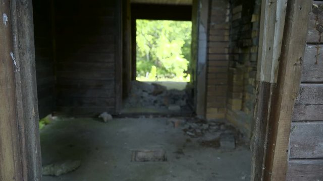 A ruined bunk house with rocks found on the door and floor of the building