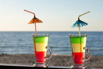 Cocktails with tubes on the sandy beach