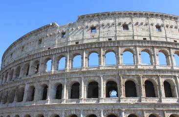 Naklejka premium Great Colosseum in Rome, Italy, Europe. Roman Coliseum close-up with clear blue sky.