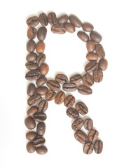Letter R made of coffee beans under a daylight isolated on white background