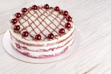 Chocolate cake with mousse, decorated cherries