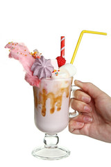 Female hand holding a milkshake on white isolated background