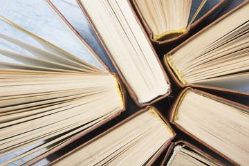 Fototapeta premium Open book, hardback books on wooden table. Back to school. Copy space for text