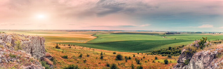 majestic landscape. old rocks and rural fields with overcast sky