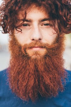 Close up portrait of young male hipster with red hair and beard