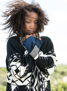 Young woman feeling cold in wind