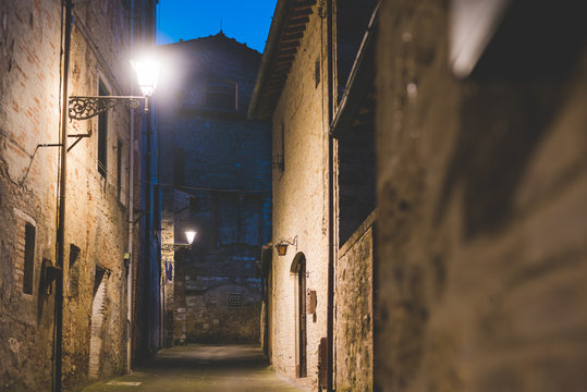 Streetlamps and alley at dusk, Colle di Val d'Elsa, Siena, Italy