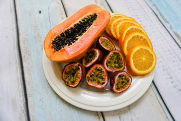 Tropical exotic fruit plate on wooden background