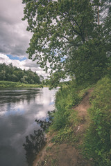 beautiful river in forest - vintage film effect