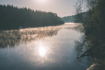 Fototapeta premium beautiful foggy river in forest - vintage film effect