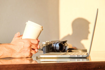 Man's hands holding blank coffee cup