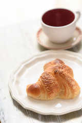 Croissant and coffee cup