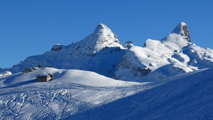 Ski slope on Mt Klingenstock and snow covered mountains