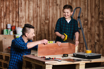 construction of father and son in the garage, family concept