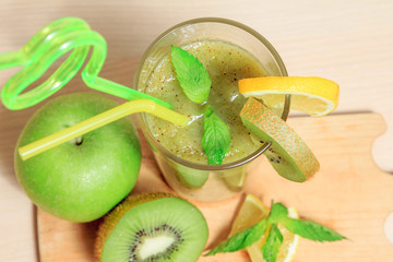 Fototapeta na wymiar Green apple and kiwi smoothie with lemon and mint