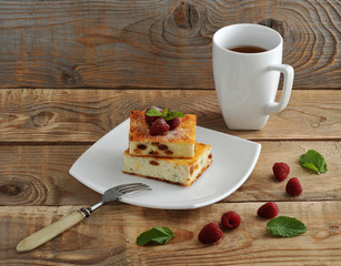 cottage cheese casserole with raisins and a mug of tea