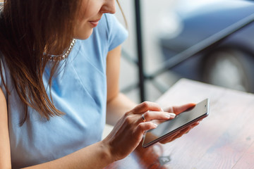 A young woman is using her smart phone