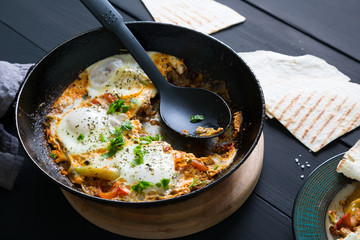 Shakshuka and pita. Scrambled eggs with vegetables and spices