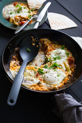 Shakshuka and pita. Scrambled eggs with vegetables and spices