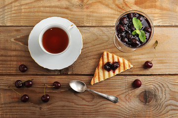 cup of tea and cherry jam, bread toast with jam