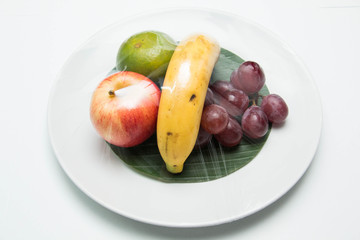 fruit in a plate on a white background