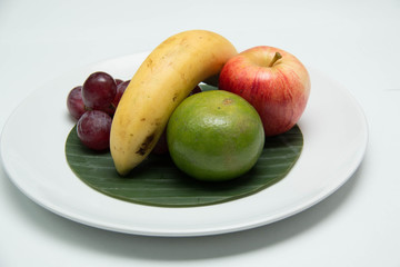  fruit in a plate on a white background