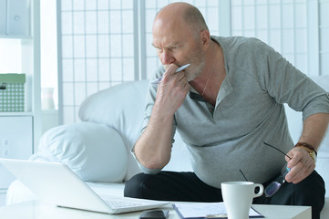 Fototapeta premium Mature businessman working with laptop