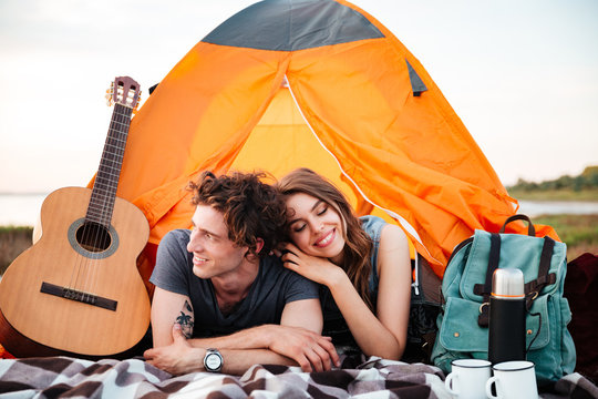 Happy Young Couple Camping On The Beach