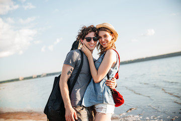 Happy young hipster couple in love at the beach
