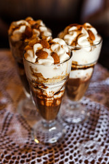 Sweet dessert - chocolate and vanilla pudding in glasses