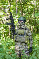 Forces soldiers in the woods with a Kalashnikov