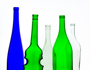 colored empty glass bottles for wine isolated on white background