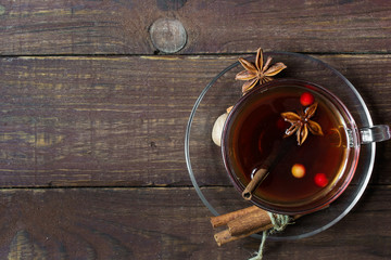 hot spiced tea with berries in a glass cup