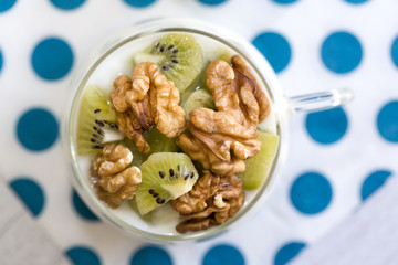 Glass with Plain yogurt with kiwi and nuts