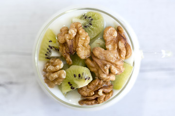 Glass with Plain yogurt with kiwi and nuts