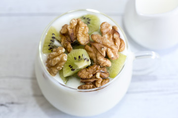 Plain yogurt with kiwi and nuts with milk jug