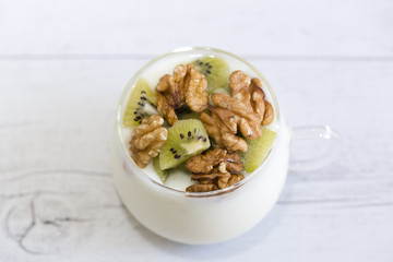 Glass with Plain yogurt with kiwi and nuts