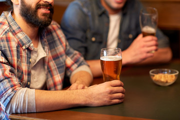 happy male friends drinking beer at bar or pub