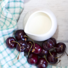 Fototapeta na wymiar Fresh cherries and milk