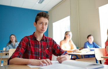 group of students with books at school lesson
