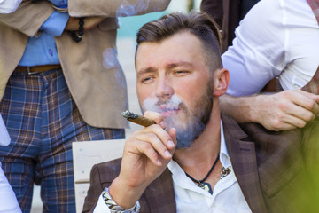Elegant bearded man smoking a cigar