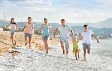 Parents children running on beach