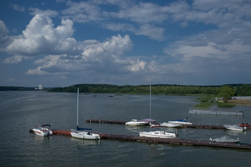 Fototapeta na wymiar Pier with several sailing yachts in daylight