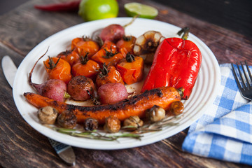 stewed and grilled  food in red bowl: radish, tomato, pepper, chili, onion, garlic, carrot, peas, rosemary, red currant