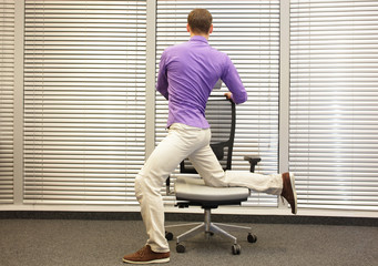 man exercising on chair in office, healthy lifestyle