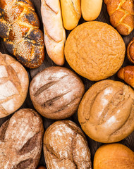Many mixed breads and rolls shot from above.